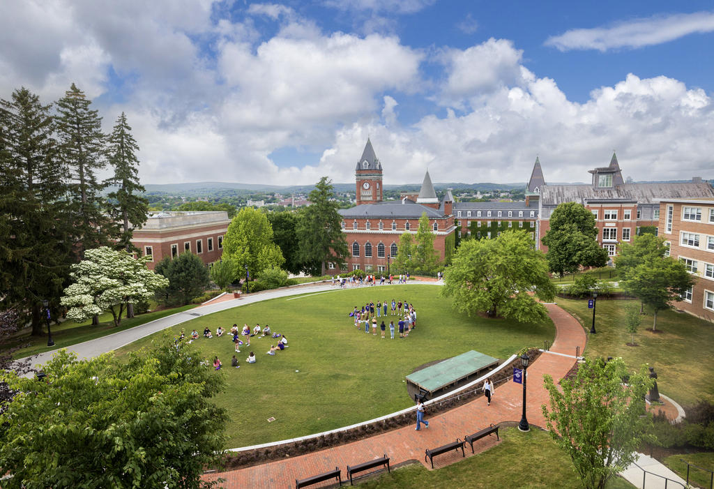 An elevated view of a college quad with a group of students standing in a circle
