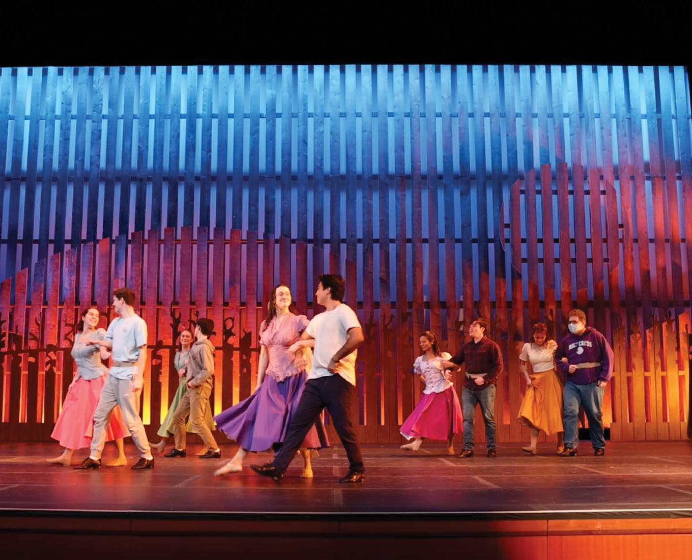 Cast members of the musical Oklahoma! practice on stage at Holy Cross.