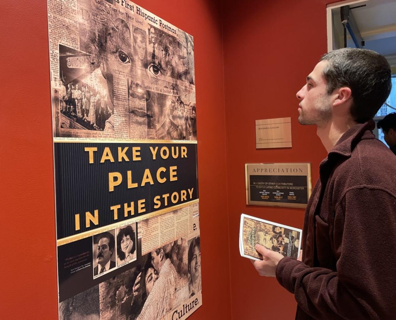 Man looks at exhibit on Latino history in Worcester.