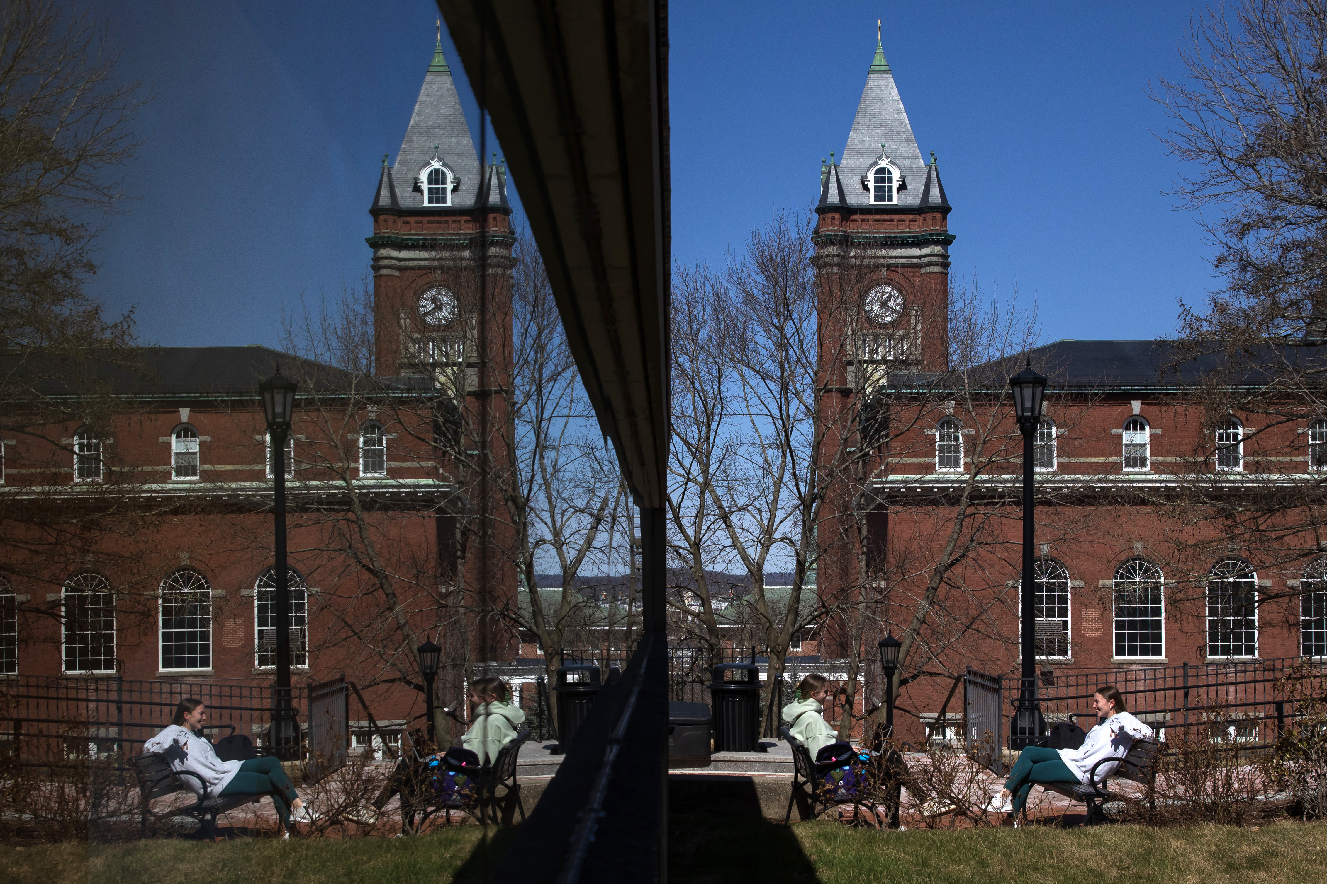 two students reflected in glass of Dinand