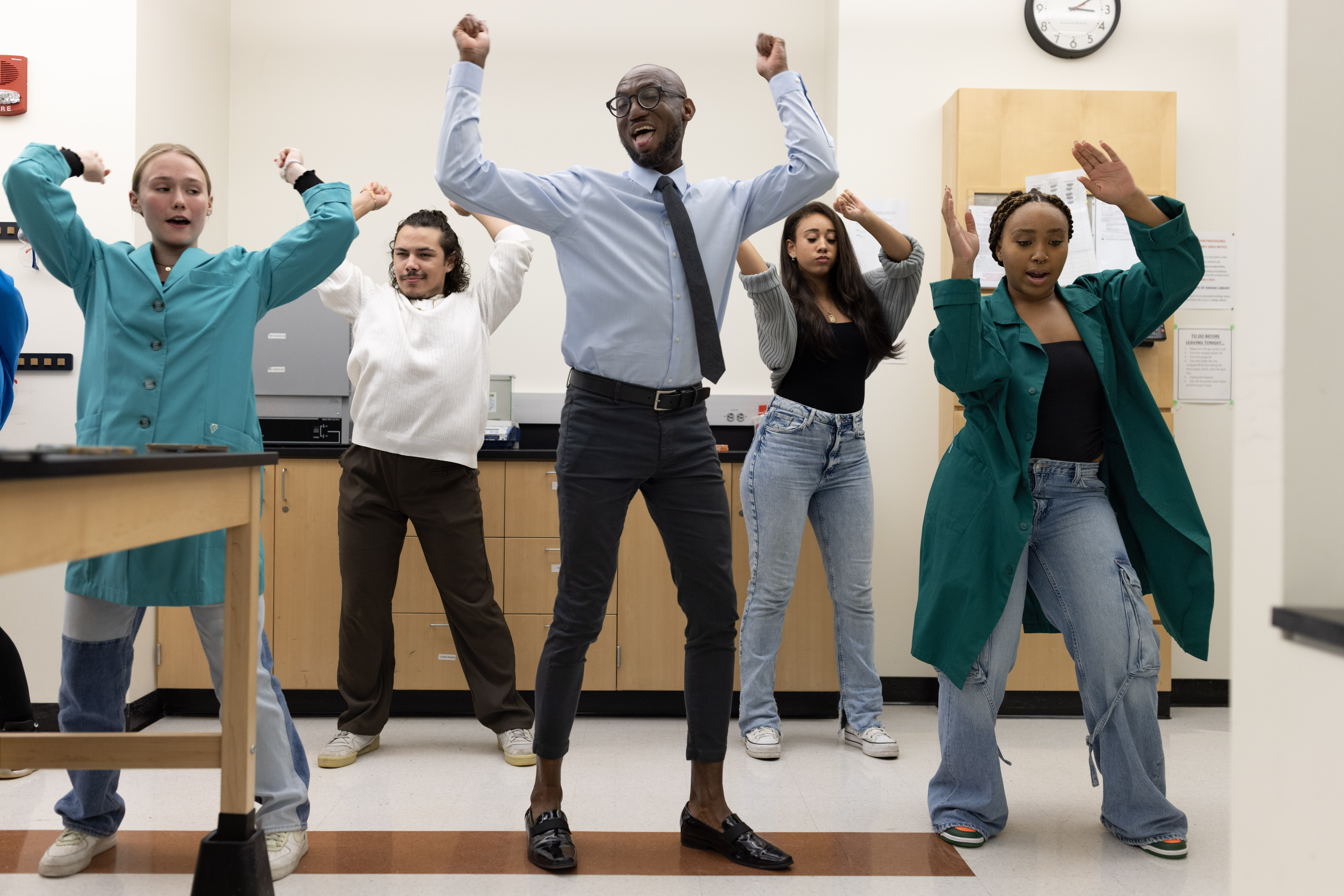 A professor dances with four students