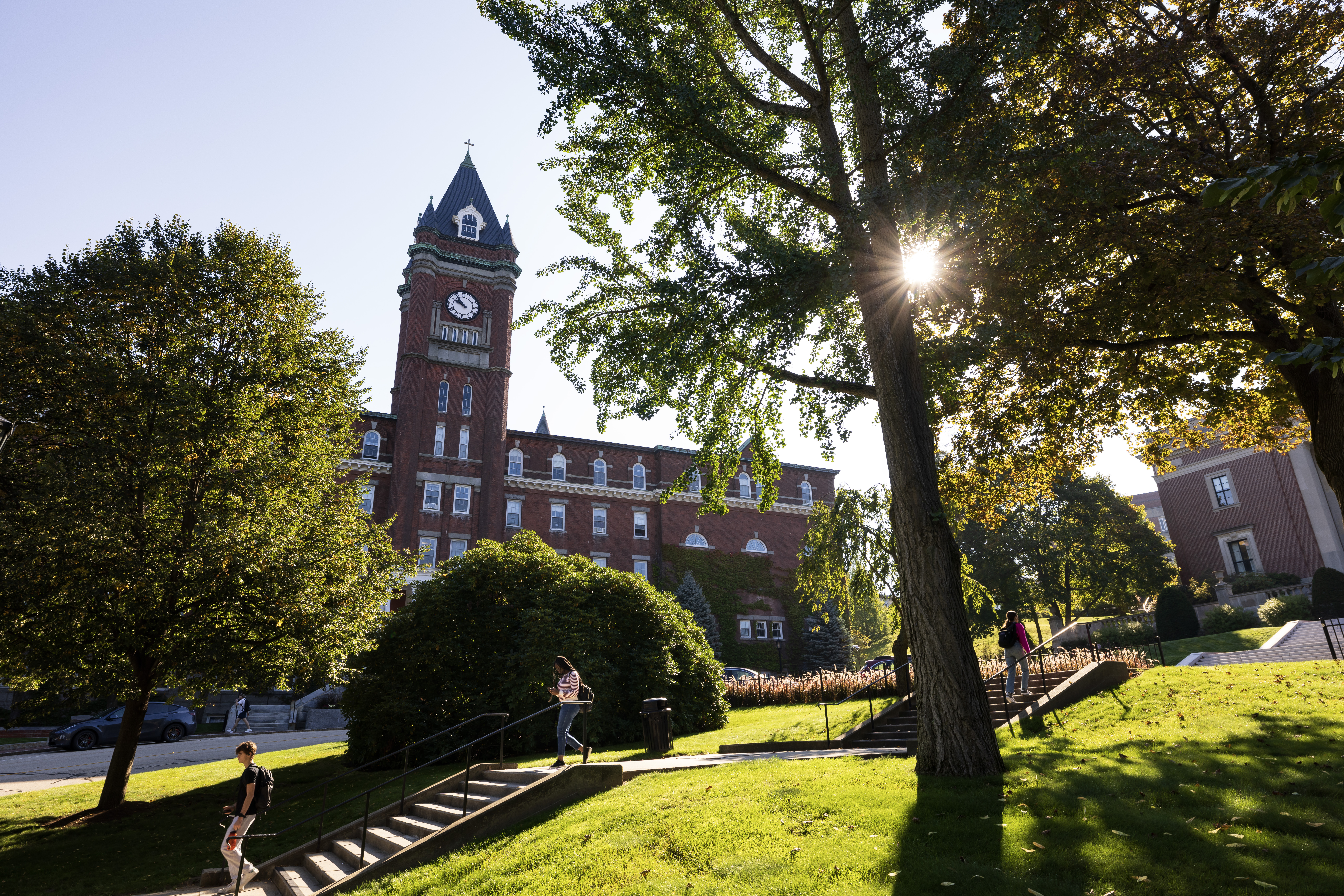 Students walk down stairs with O'Kane tower in background