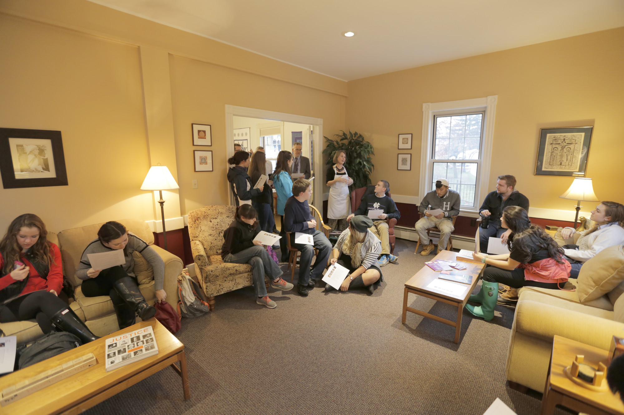 People sit around a living room.