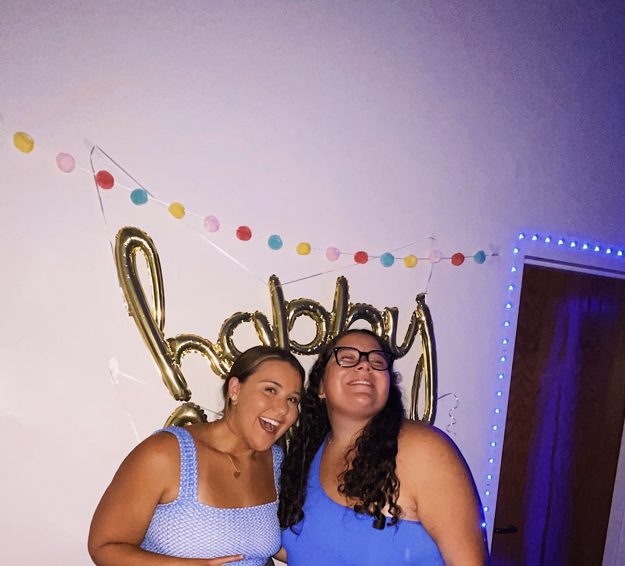 Two young woman smiling at a party