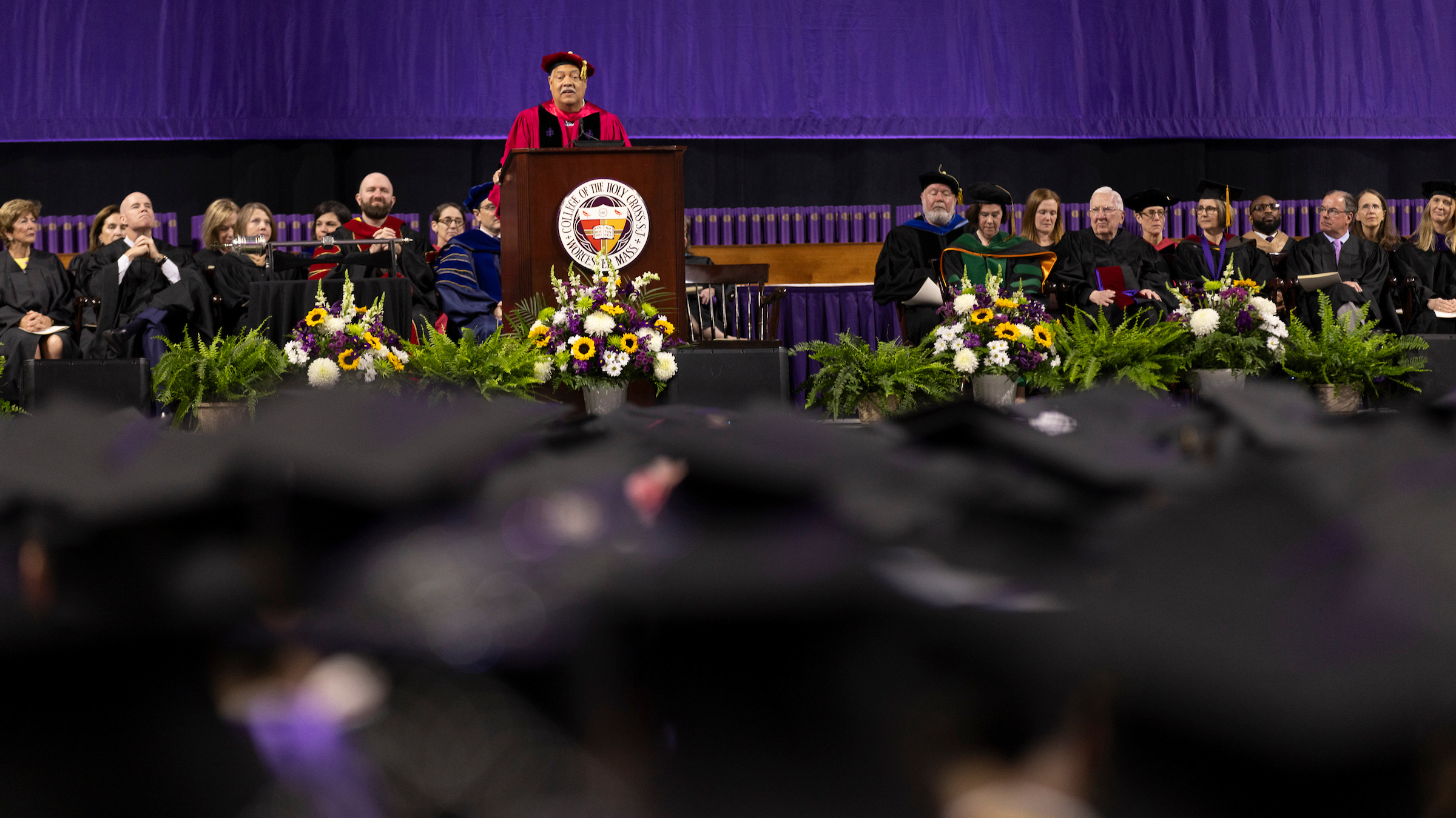 View from the audience of the platform party during a college commencement.