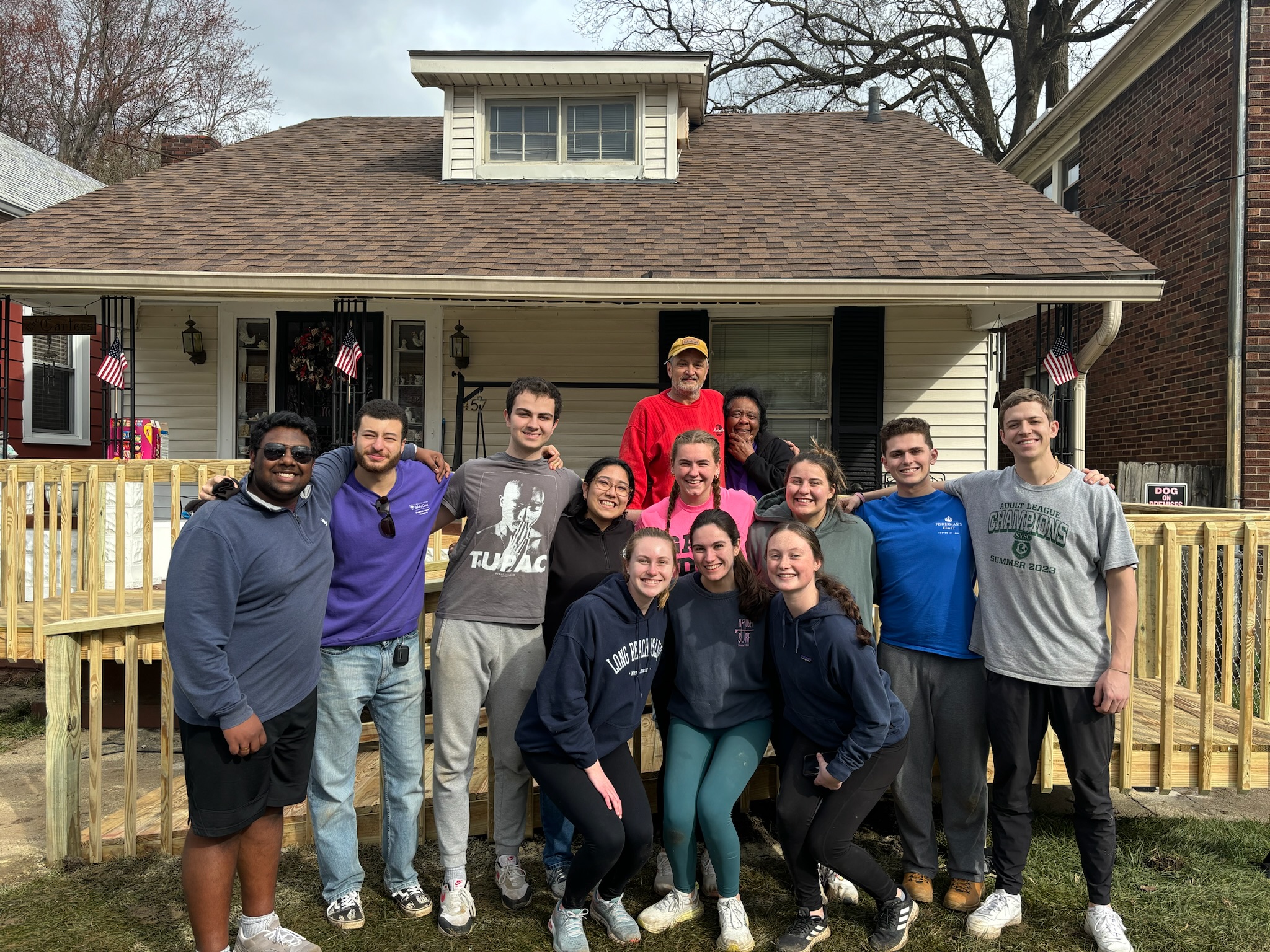 A group of young people stand in front of  home in Louisville, Kentucky