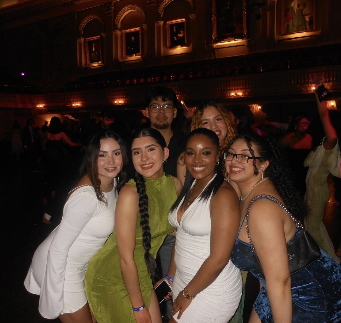 A photos of young people posing for a picture in dresses at the 100 days ball