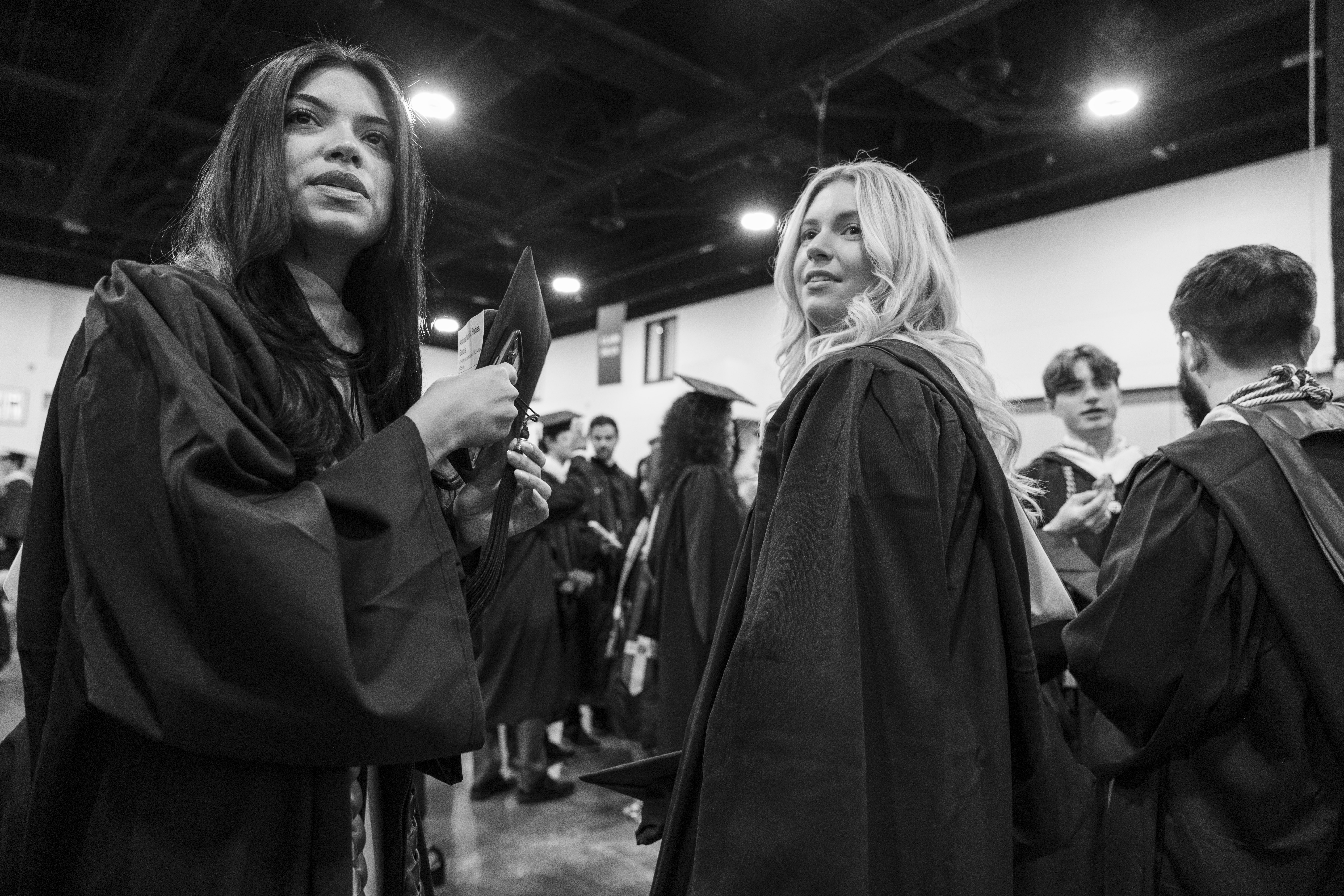 College graduates wait backstage before commencement.