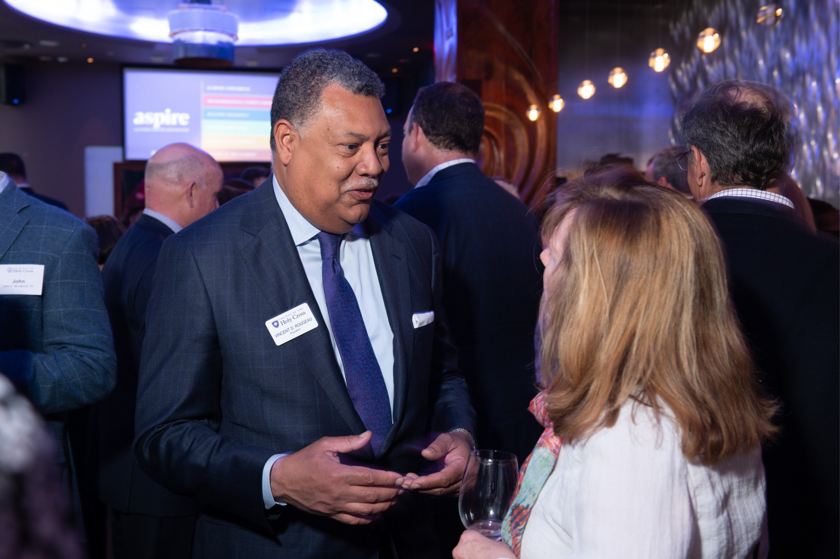 president rougeau talking with an alumna