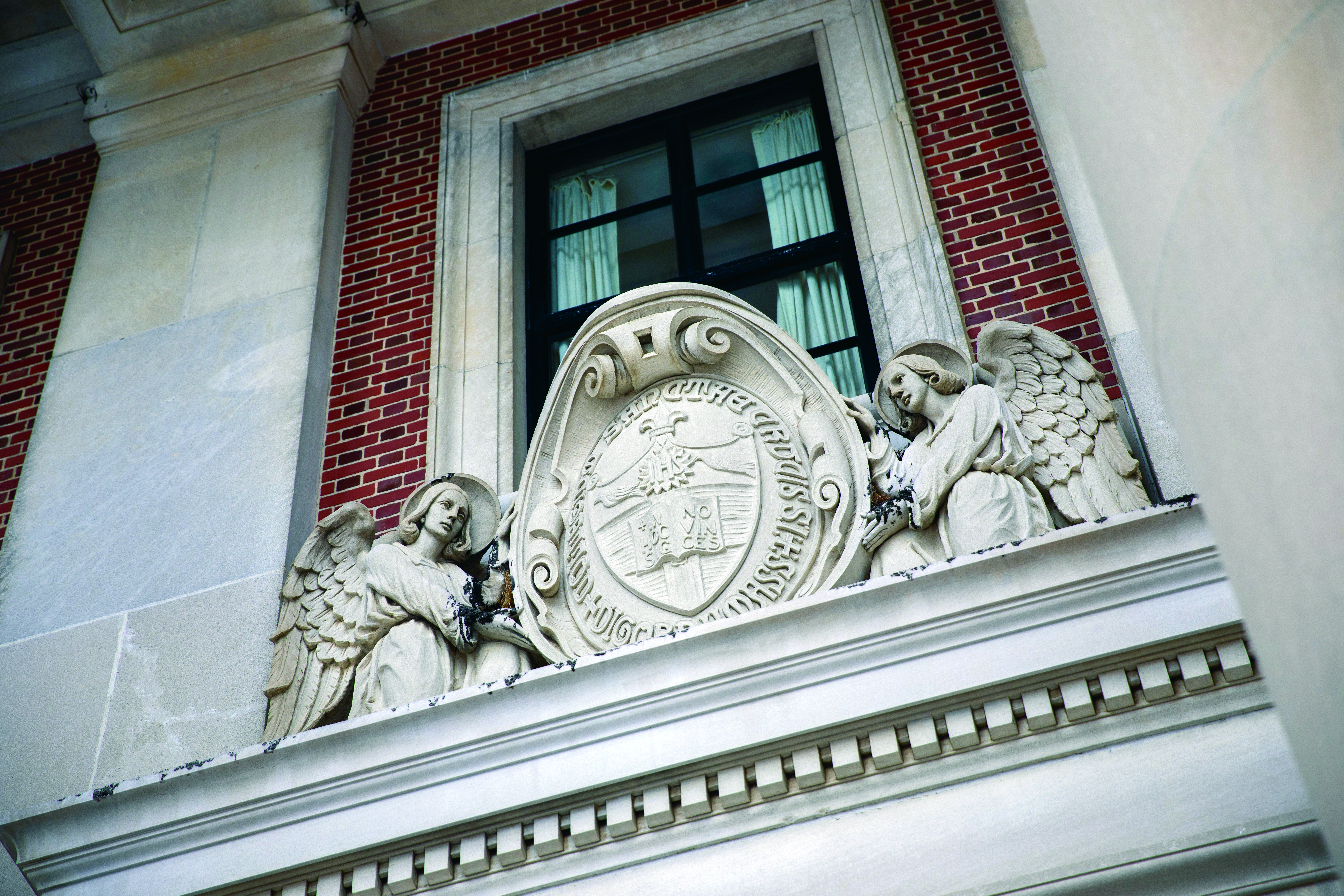 The College seal above the library's doors
