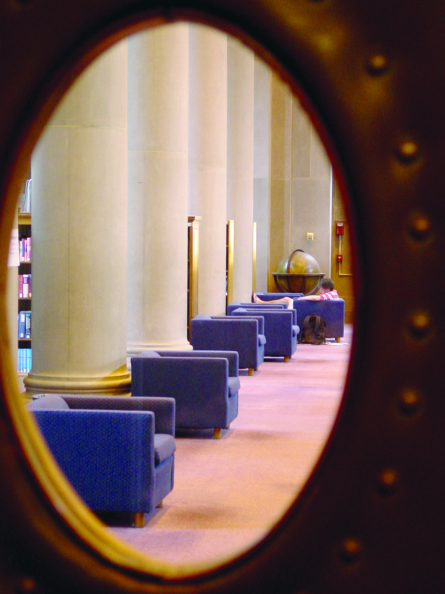 Chairs viewed through an oval window