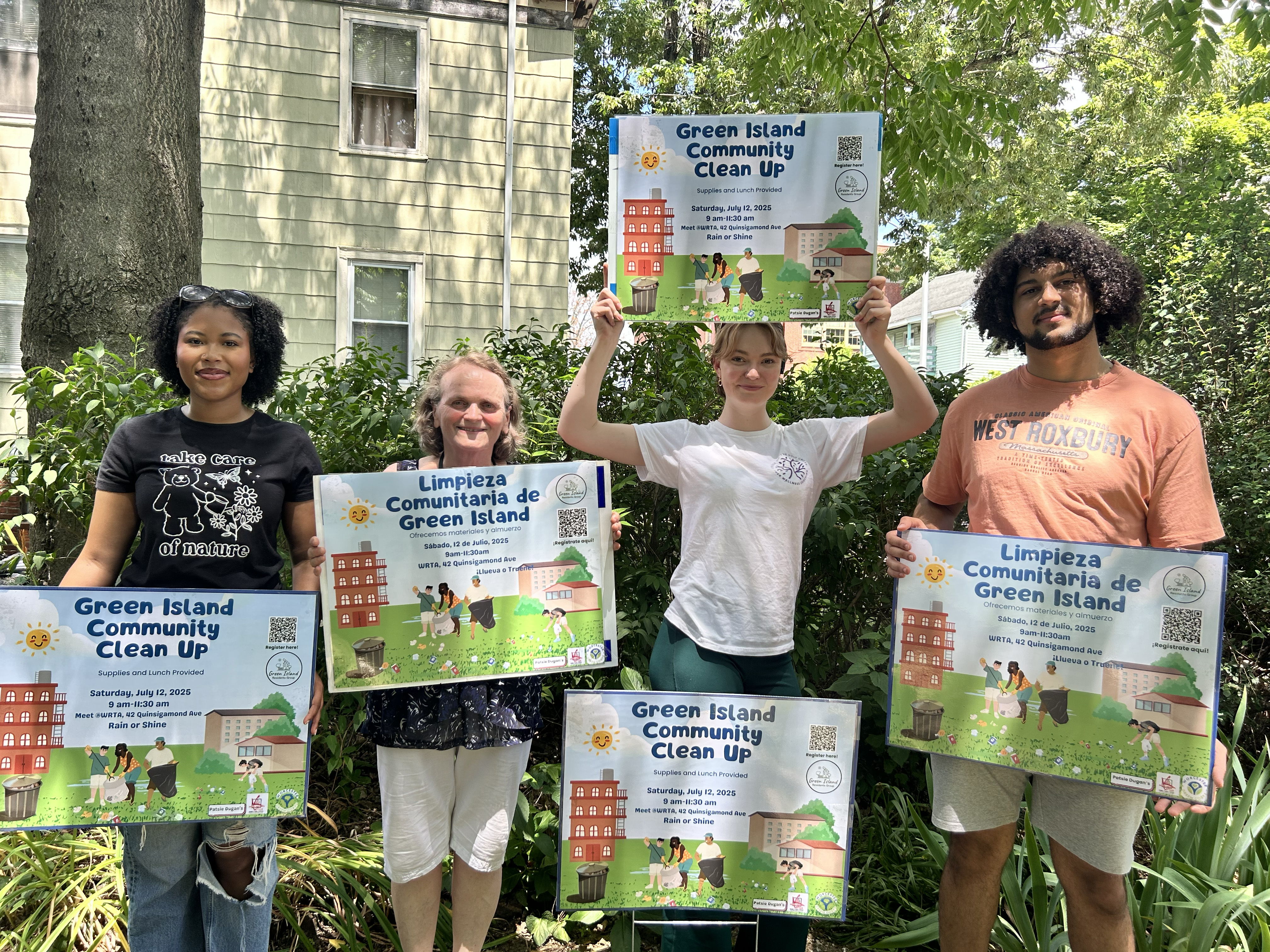 People holding up community clean up signs