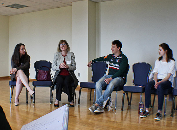 A group of students meet with Mary Beth Sheridan after the panel discussion.