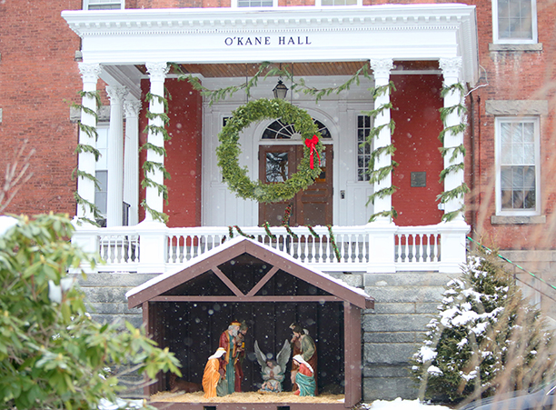 Snow falls over the crèche in front of O’Kane Hall.