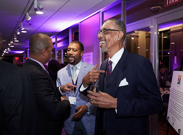 Three BSU alumni talk to each other.