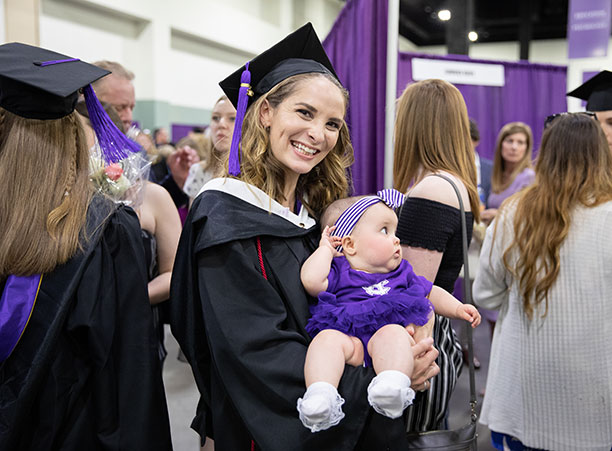 Students celebrate with their friends and family at the reception following the ceremony.