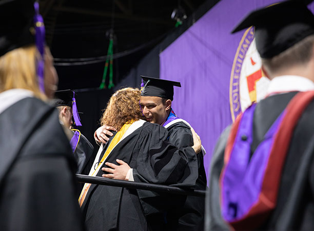 Shawn Maurer, dean of the Class of 2019, hugs a student.