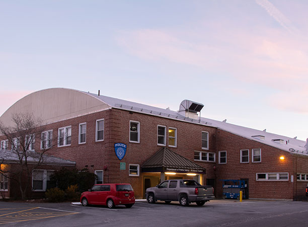 A photo of the Field House against a sunset