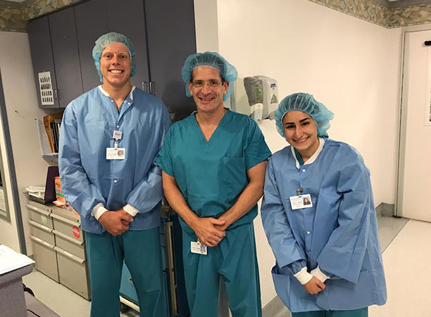 Lucas Hildreth '19 (left), a biology major, interns at NYU Winthrop Hospital in Mineola, New York.