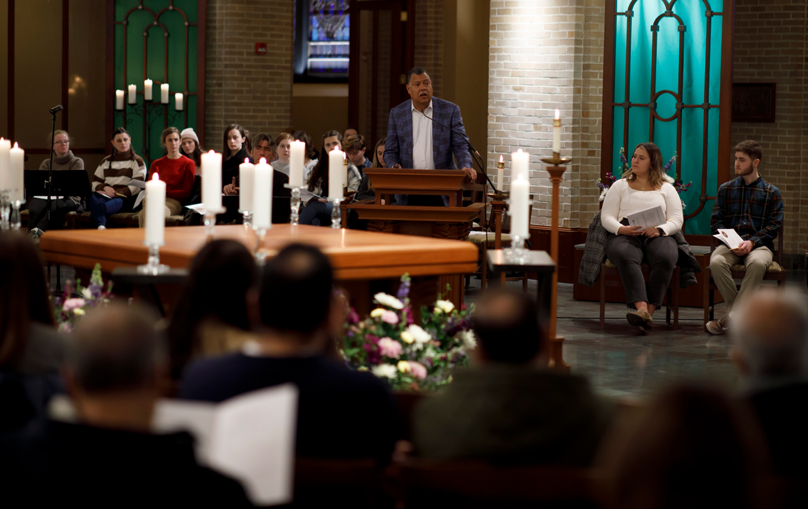 Man at lecture addresses a group of people