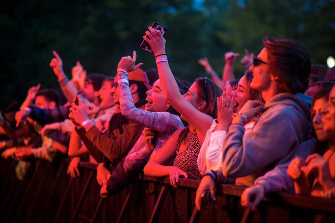 Students watch a concert in a crowd on campus.