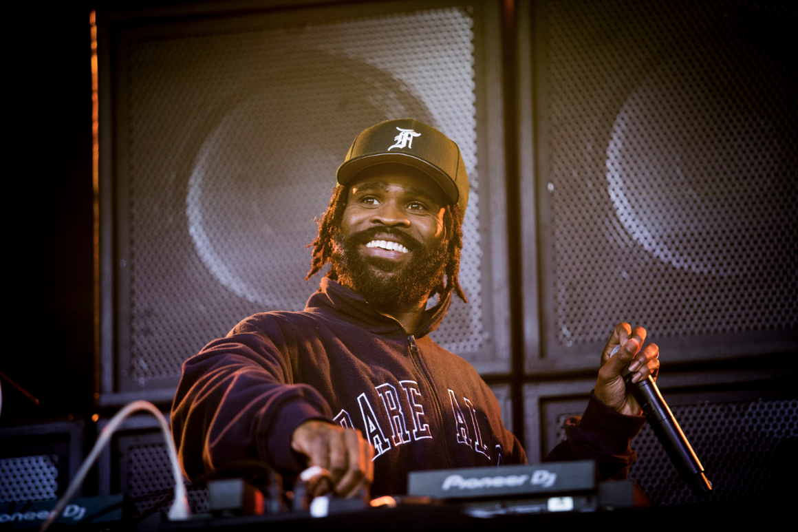 A DJ performs at a campus concert.