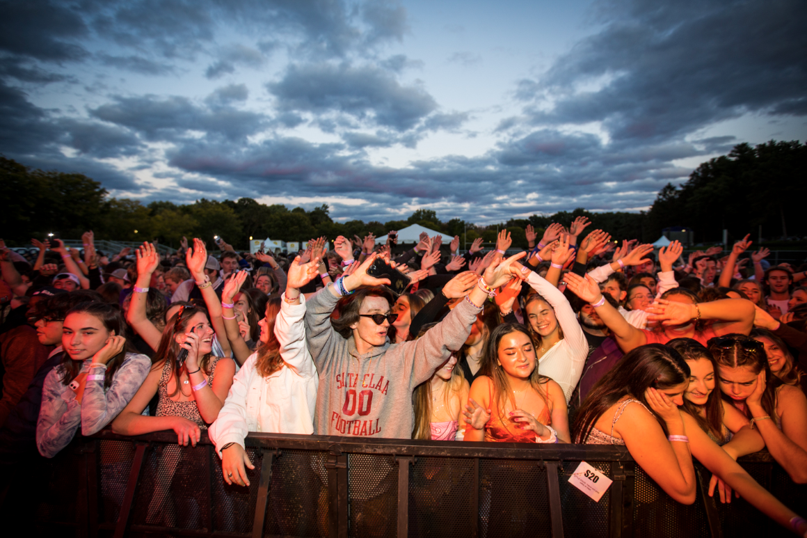 Students watch a concert in a crowd on campus.