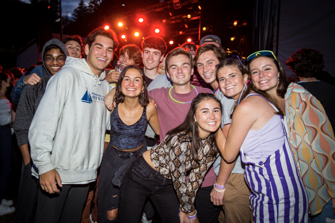 Students pose together for a photo at a campus concert.