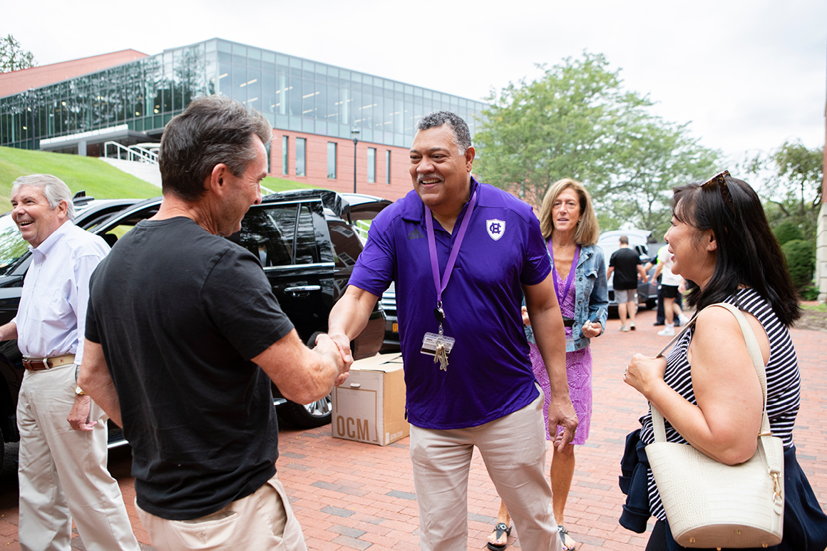 Holy Cross President Vincent Rougeau and Tracy Barlok, vice president for advancement, greet parents dropping off their Crusader at Wheeler Hall on Aug. 29.