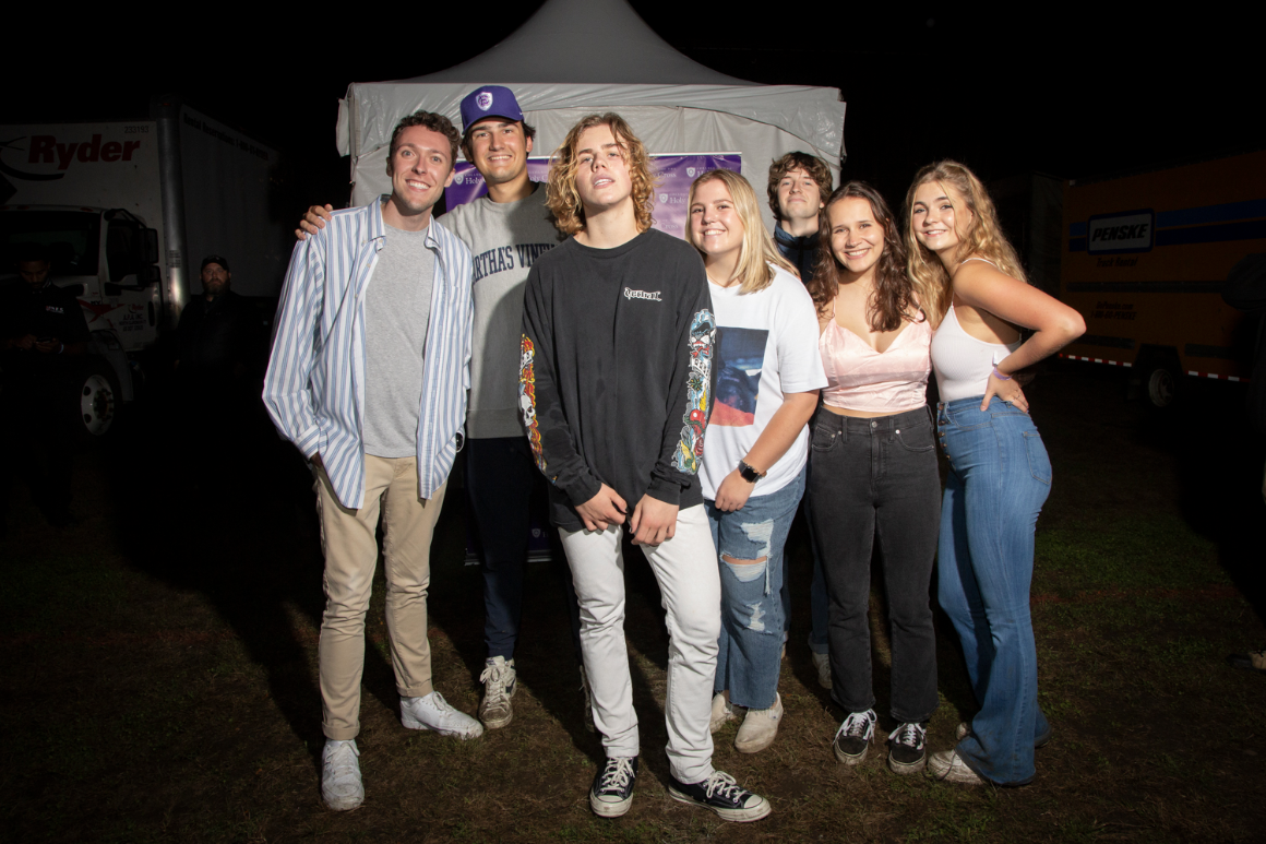 Students pose with the concert performer.