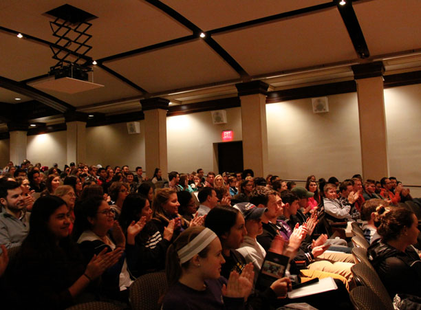 A crowded Seelos Theater applauds the cast of “Walking Still: Rompiendo Barriers y Building Puentes,” the kick-off event for the Academic Conference presented by Uni2ACT, Holy Cross’s bilingual theatre troupe.