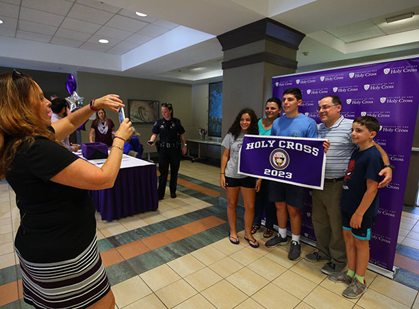 a student and his family take a picture