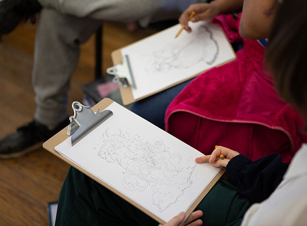 A clipboard with a pencil drawing on it