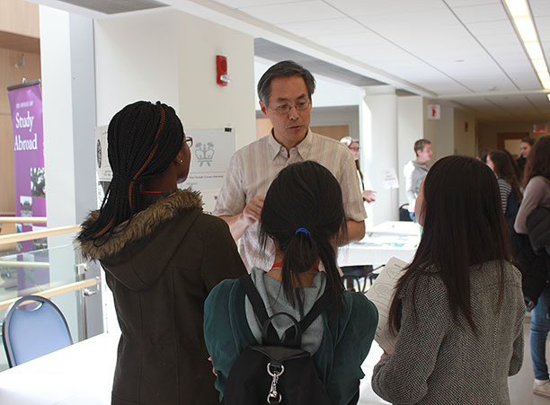 A professor speaks with high school students in the Integrated Science Complex.