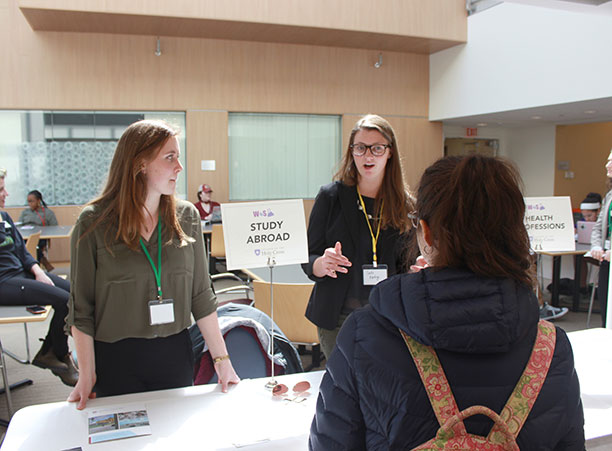 Holy Cross students talk to a high school student about the study abroad program.