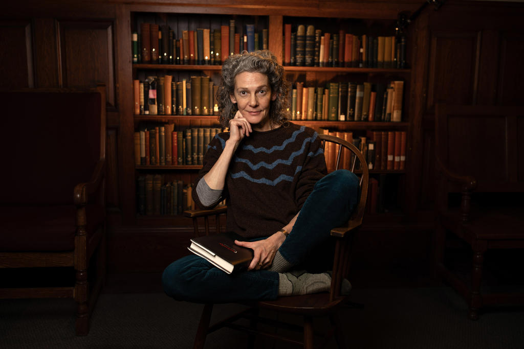 A portrait of an english professor in a library 