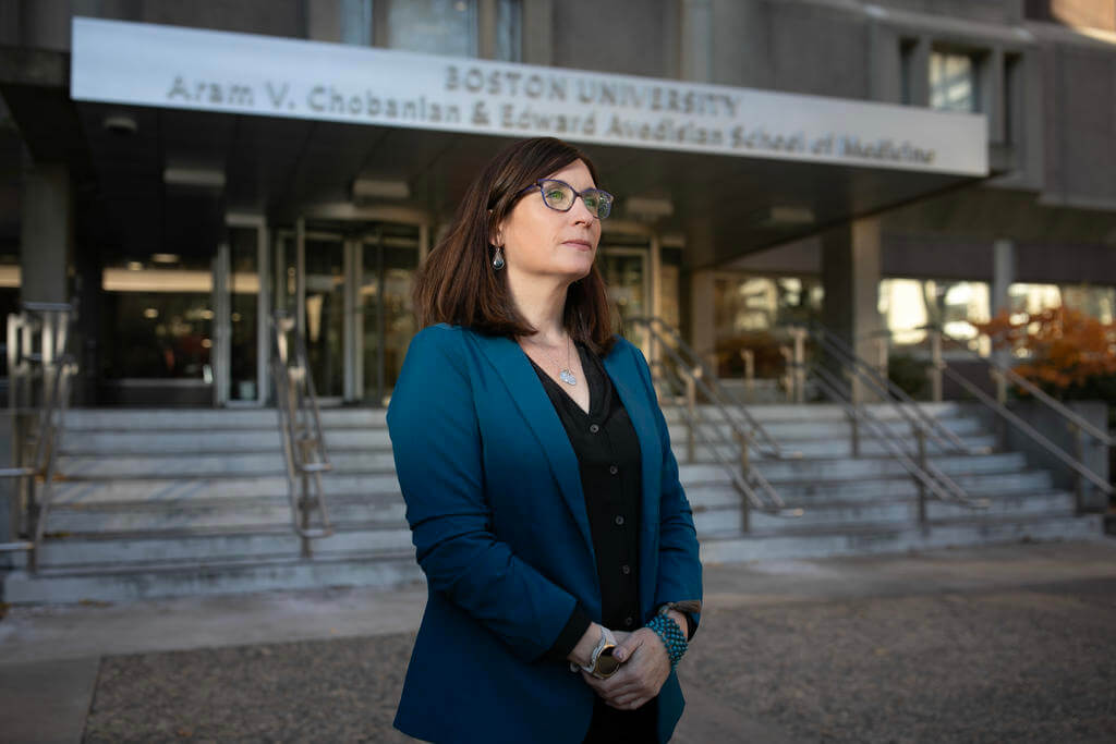 Woman wearing glasses looks off in the distance