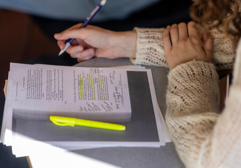 Student annotating a printed poem