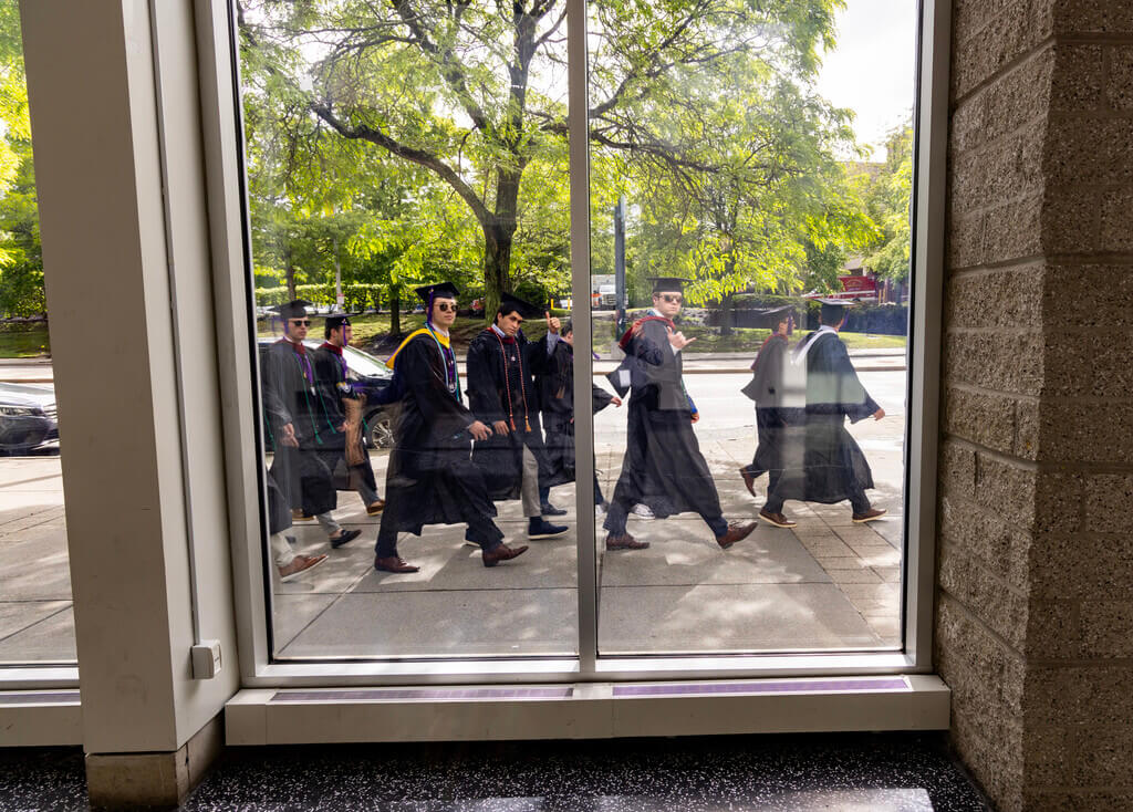 Students walking in caps and gowns