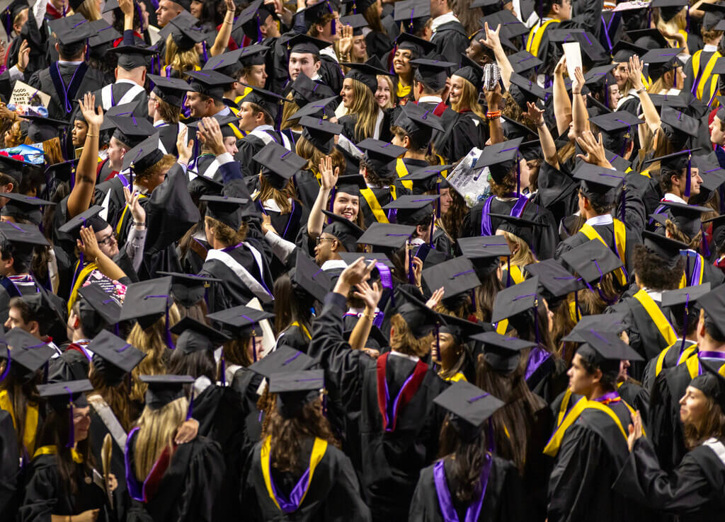 Aerial view of the 2025 graduates of the College of the Holy Cross in their caps and gowns at the DCU center