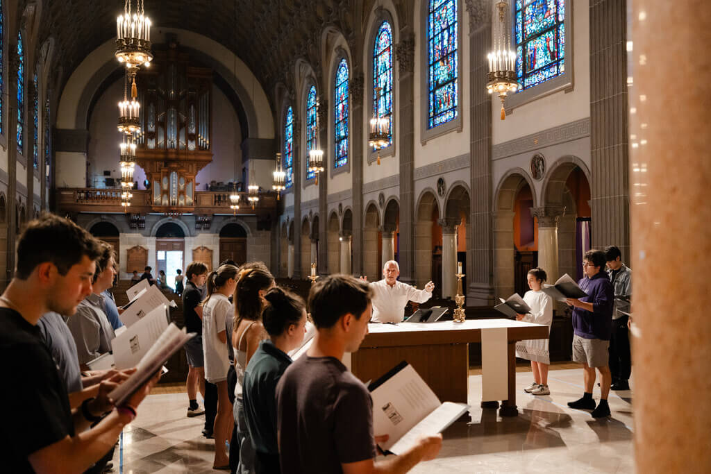 Students and teacher at chant rehearsal on altar of St. Joseph Chapel.