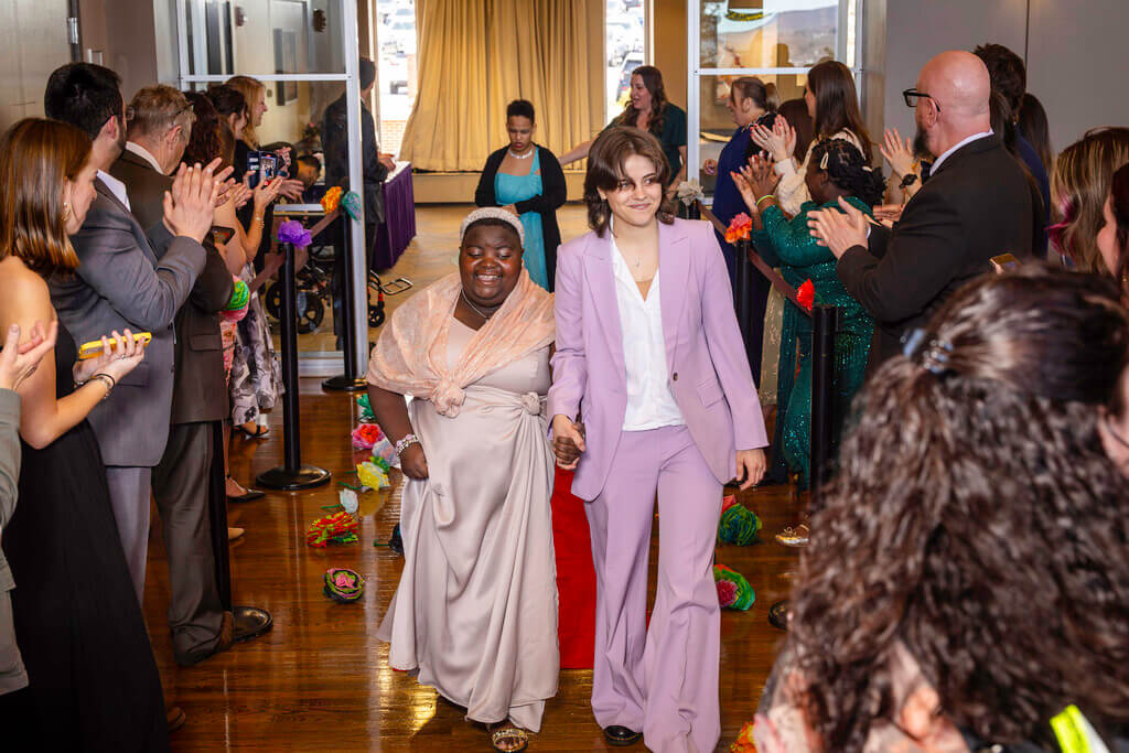 Holy Cross student and WPS transition student walking into prom