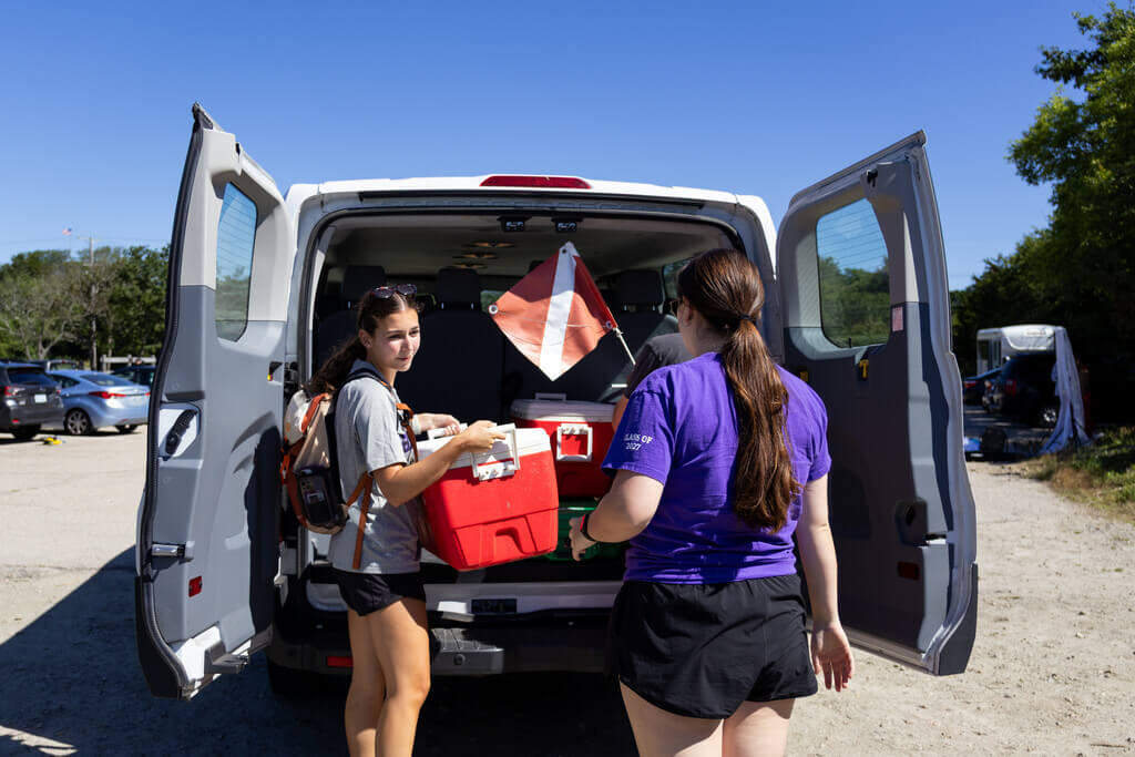 Two students unloading a van