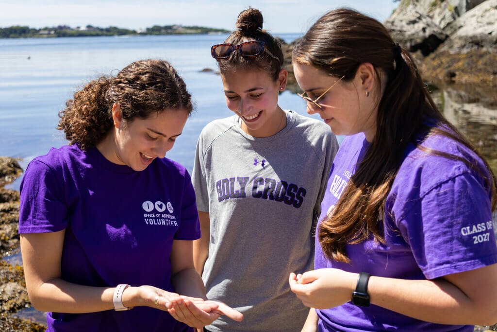 Three students looking at an ocean organism