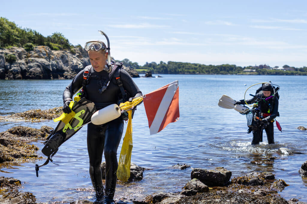 Two scuba divers returning from the water