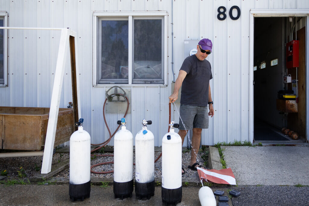 Justin McAlister washing scuba tanks