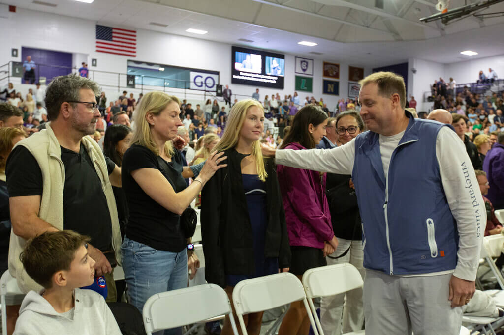 A family blessing their student