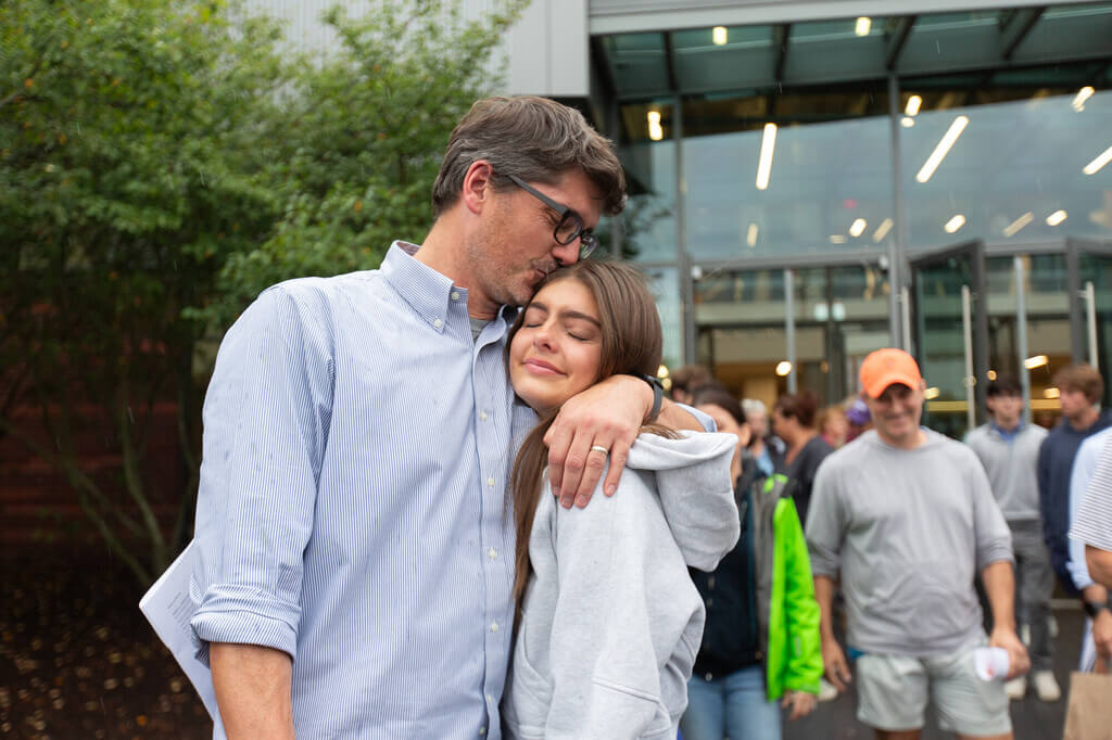 A dad hugging his daughter