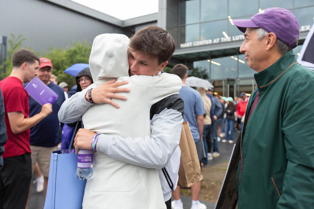 A parent hugging their son