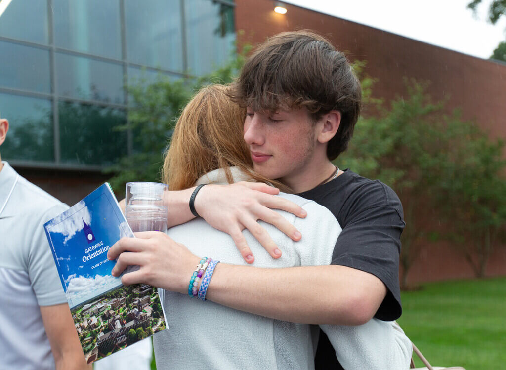 A mother and son hug